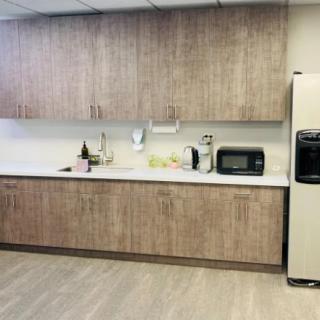Modern kitchen with wooden cabinets and various appliances.