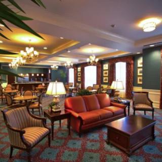 A cozy lounge area featuring comfortable seating, ambient lighting, and elegant decor.