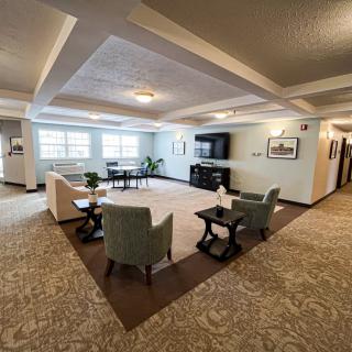 A spacious living room with comfortable seating and a large television.