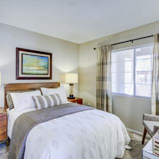 A cozy and well-decorated bedroom featuring a comfortable bed, stylish furniture, and a warm atmosphere.