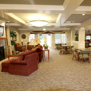 A spacious and elegantly designed lounge area with comfortable seating and cozy lighting.
