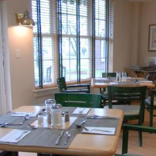A cozy restaurant dining area with neatly set tables and natural lighting.