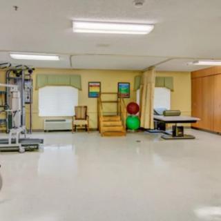 A rehabilitation room equipped with exercise machines and therapy tools.