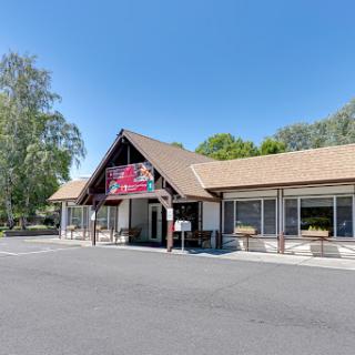 A charming restaurant with a traditional architecture set against a clear blue sky.