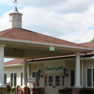 A building entrance with a cupola and red roof.