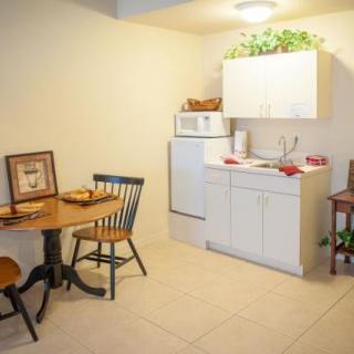 Cozy kitchen with a dining area featuring a round table and two chairs.