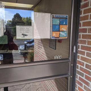 Entrance of a building featuring various signs and door design.