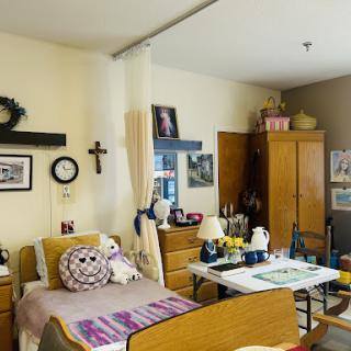 A cozy bedroom setup with personal touches and a warm atmosphere.