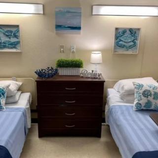 A neatly arranged bedroom with twin beds and decorative artwork.