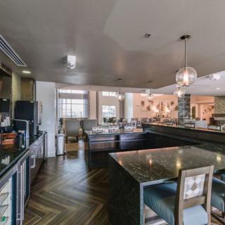 A modern kitchen interior with stylish furniture and elegant lighting.