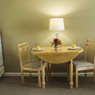 A cozy dining area with a round table set for two.