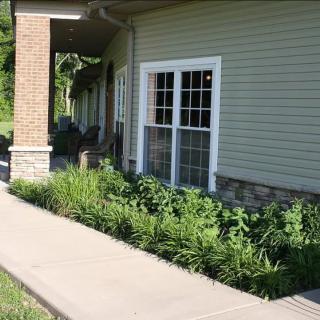 A building exterior with a pathway and landscaped garden.