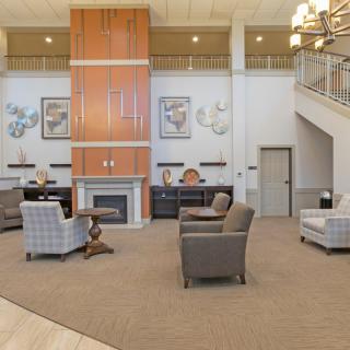A modern lobby with comfortable seating, a fireplace, and contemporary decor.