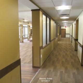A spacious, well-lit hallway in an office or commercial building.