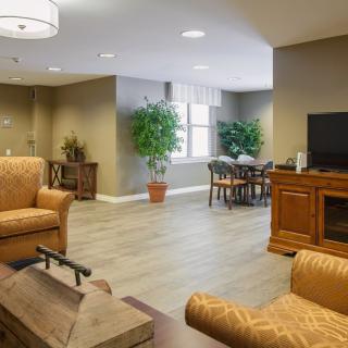A cozy living room with comfortable seating, a television, and homey decor.