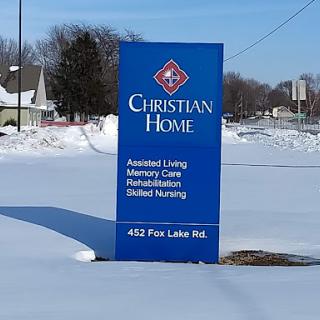 Sign for Christian Home, offering various care services, surrounded by snow.