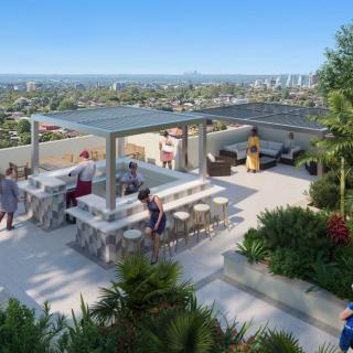A modern rooftop terrace with a view of the city, featuring seating areas and lush greenery.