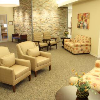 A cozy and welcoming waiting area with comfortable seating and natural decor.