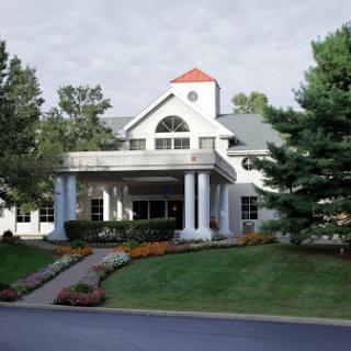 A beautifully designed residential building with a welcoming entrance and well-maintained landscaping.