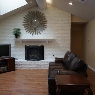 Cozy living room featuring a modern fireplace and comfortable seating.