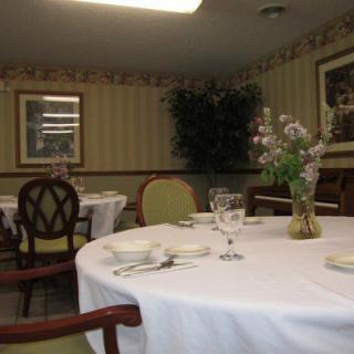A neatly set dining room table with elegant decor.