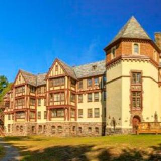 A historic building with Tudor-style architecture under a clear blue sky.