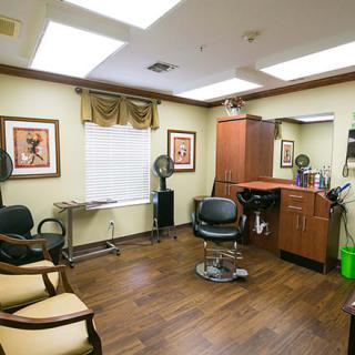 A cozy hair salon interior featuring a barber chair, mirror, and stylish decor.