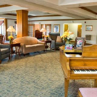 Elegant hotel lobby with a grand piano and comfortable seating.