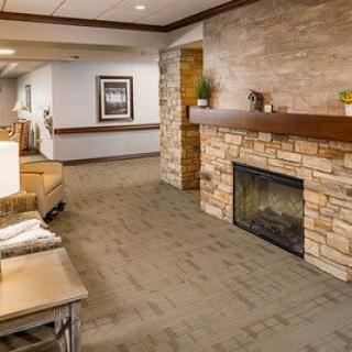 A cozy lobby with a stone fireplace and comfortable seating area.