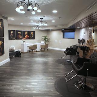 A modern hair salon featuring sleek furniture, artistic decor, and stylish lighting.