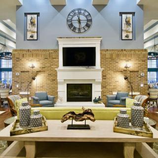 A stylishly decorated living room featuring a central fireplace, modern furniture, and elegant decor.