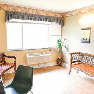 A bright room with vintage-style furniture and a large window.