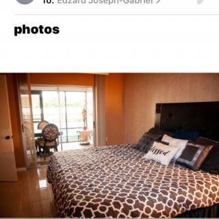 A modern bedroom with stylish decor and ample natural light.