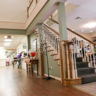A cozy interior hallway featuring a wooden staircase and polished floors.