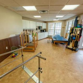A spacious and well-equipped physical therapy room designed for rehabilitation exercises.