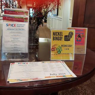 A table display showcasing SPICE restaurant menus and a promotional flyer for Nickel Bingo.