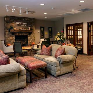 A cozy living room with comfortable sofas and a fireplace.