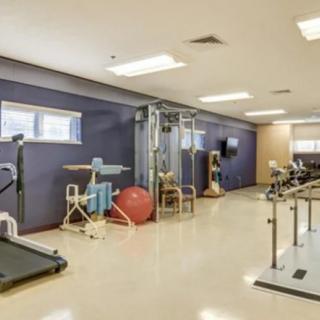 A well-equipped gym room featuring various fitness machines and exercise tools.