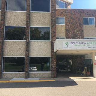 A modern commercial building showcasing a blend of stone and concrete architecture.