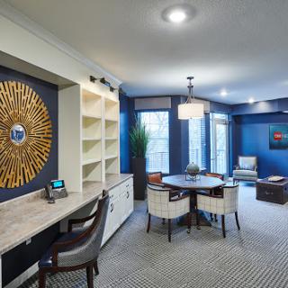 A modern office space featuring stylish furniture and a calming blue color palette.
