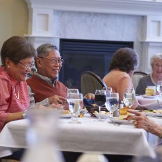 A group of seniors enjoying a meal together in a restaurant setting.