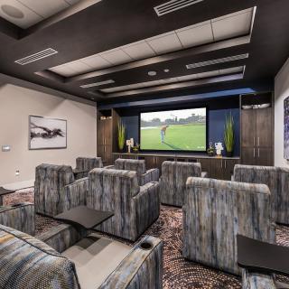 A modern home theater with comfortable seating and a large screen for entertainment.