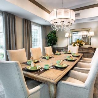 A beautifully designed dining room with elegant furnishings and a sophisticated table setting.