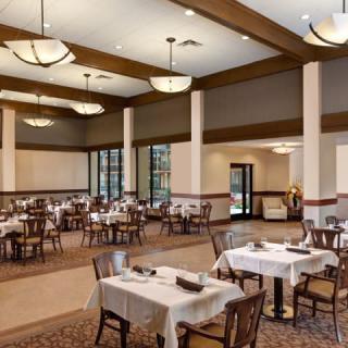 An elegant dining room with set tables ready for guests.