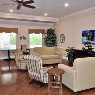 A cozy living room featuring comfortable seating and a television.