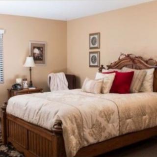 A cozy and traditionally decorated bedroom with a large bed and elegant furnishings.