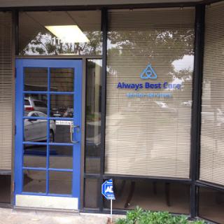 A storefront with a blue door and signage, indicating accessibility.