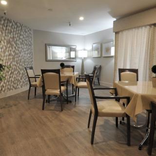 A modern dining area with neatly arranged tables and chairs, featuring stylish interior design elements.