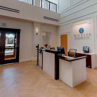 A modern reception area with a central desk and office entrance.
