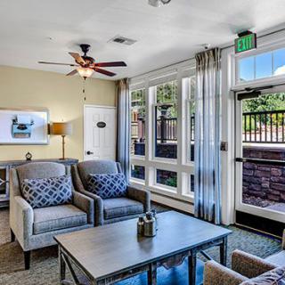 A modern living room with comfortable seating and large windows.